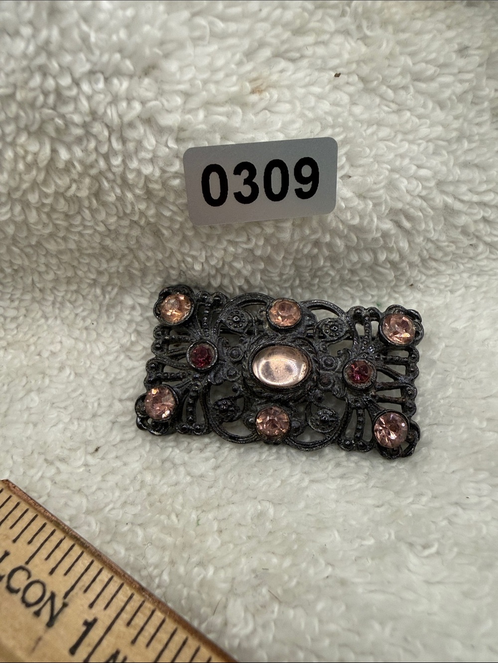 Vintage-Inspired Black Filigree Brooch with Pink and Red Stones